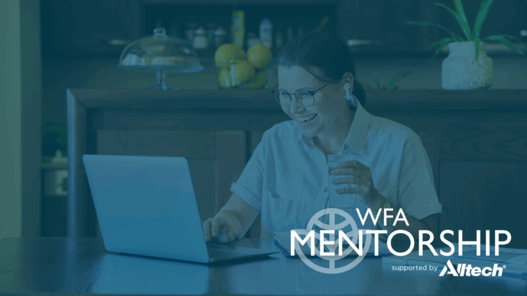 Women on laptop, holding a glass of water